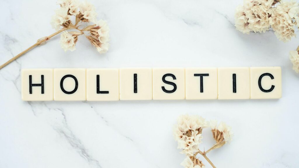 Word holistic written with white plastic plates to symbolize holistic approaches to sobriety