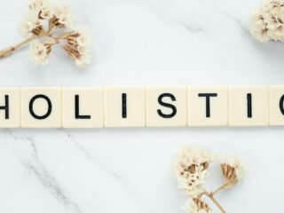 Word holistic written with white plastic plates to symbolize holistic approaches to sobriety